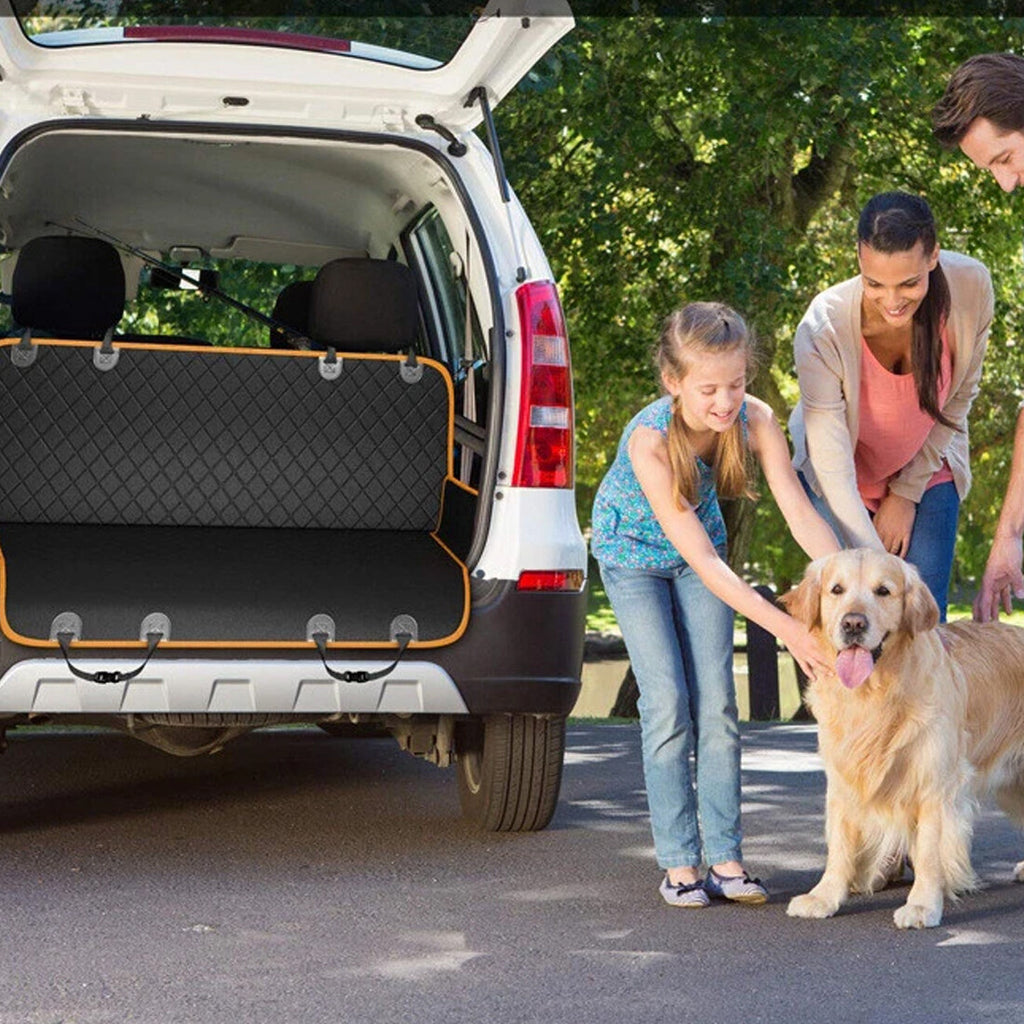 Black and orange dog car seat cover fitted as a cargo liner in the open boot of a white car