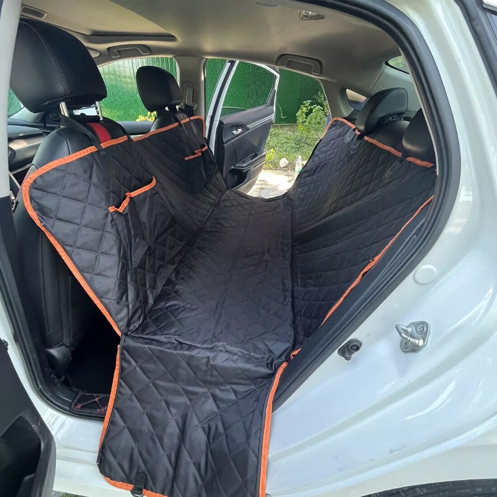 Black waterproof dog car seat hammock with orange trim fitted across a car’s rear seats