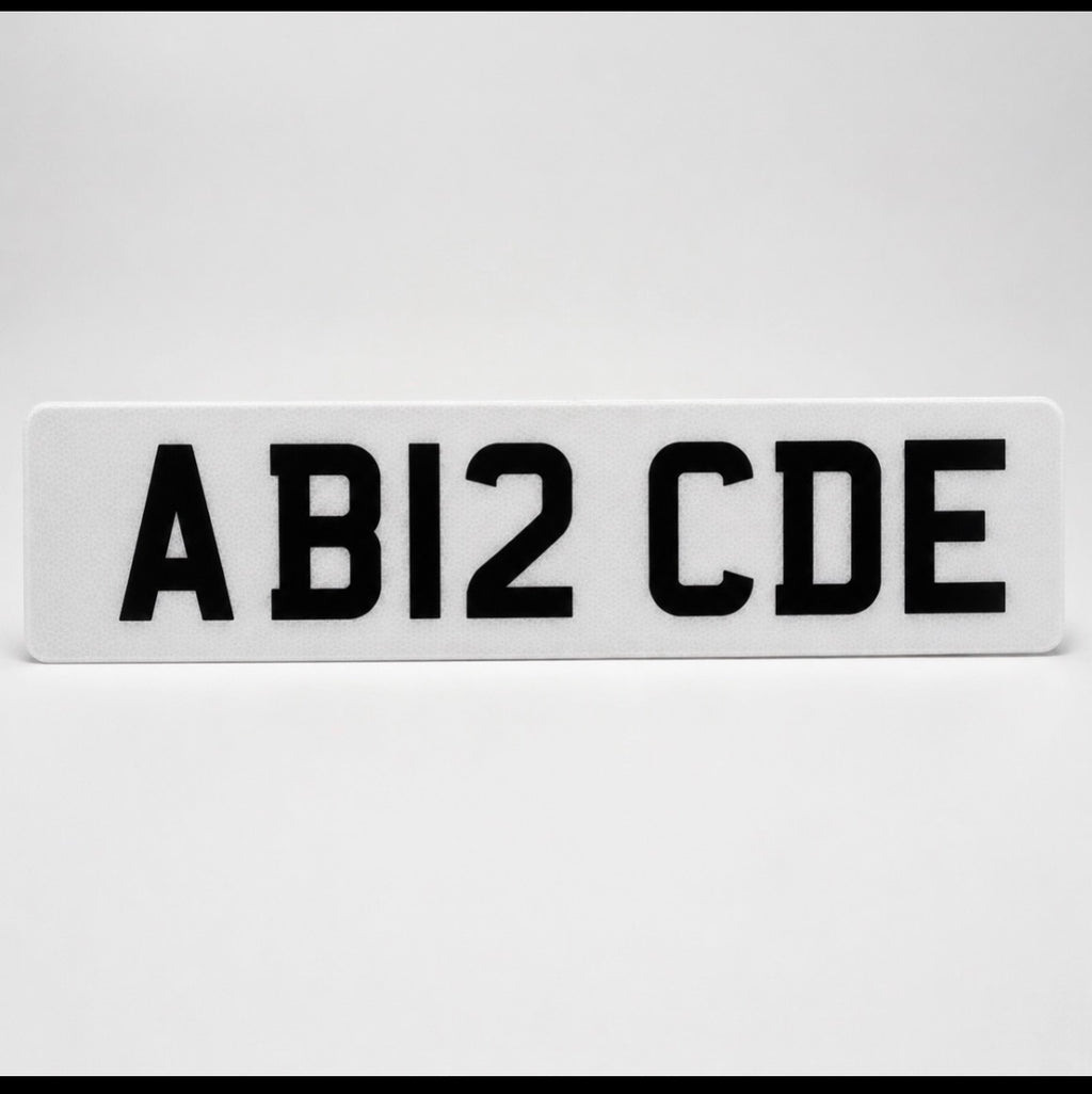 Single white front number plate showing AB12 CDE on a light grey background